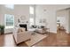 Comfortable living room with high ceilings, natural light, hardwood floors, fireplace, and neutral decor at 105 Runningdeer Dr, Mooresville, NC 28117