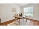 Bright office space featuring a wooden desk with metal legs, a comfortable chair, and natural light at 105 Runningdeer Dr, Mooresville, NC 28117