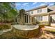 A stone patio with a fireplace and screened in porch accentuates the house's backyard at 108 Bare Foot Ln, Mooresville, NC 28117