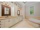 Elegant bathroom with double vanities, granite countertops, and a soaking tub at 108 Bare Foot Ln, Mooresville, NC 28117