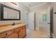 Bathroom featuring a wood vanity with a framed mirror and tile flooring at 108 Bare Foot Ln, Mooresville, NC 28117