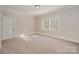 Comfortable carpeted bedroom with a large window and neutral decor at 108 Bare Foot Ln, Mooresville, NC 28117