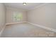 Spacious bedroom with neutral carpet, white trim and window with natural light at 108 Bare Foot Ln, Mooresville, NC 28117