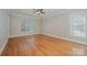 Bright bedroom with hardwood floors, large windows, and neutral wall color at 108 Bare Foot Ln, Mooresville, NC 28117