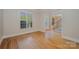 Hallway with hardwood floors offering a view of staircase and entry into another room at 108 Bare Foot Ln, Mooresville, NC 28117