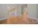 Hallway showcasing hardwood floors and staircase with iron railings, adding elegance to the home's design at 108 Bare Foot Ln, Mooresville, NC 28117
