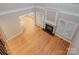 Living room with fireplace, hardwood floors, and an open layout to other living spaces at 108 Bare Foot Ln, Mooresville, NC 28117
