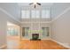 Bright living room features hardwood floors, fireplace, and high ceilings with abundant natural light at 108 Bare Foot Ln, Mooresville, NC 28117