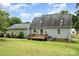Rear exterior of home with green siding, deck, and lush green yard at 109 Terrace Pl, Lincolnton, NC 28092