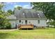 Rear exterior of home with green siding, deck, and lush green yard at 109 Terrace Pl, Lincolnton, NC 28092