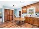 Well-lit kitchen with wood cabinets, a cozy dining table, and a convenient pantry at 109 Terrace Pl, Lincolnton, NC 28092