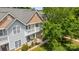 Scenic aerial view of townhomes, showcasing balconies, stone pillars and green landscaping at 11139 Dundarrach Ln, Charlotte, NC 28277
