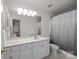 Bright bathroom with white vanity, large mirror, and combination shower and tub at 11139 Dundarrach Ln, Charlotte, NC 28277