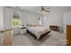 Bright bedroom features a ceiling fan, two windows and neutral colors at 11139 Dundarrach Ln, Charlotte, NC 28277