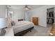 Well-lit bedroom features a ceiling fan, neutral colors, and a walk-in closet at 11139 Dundarrach Ln, Charlotte, NC 28277