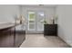 Neutral bedroom with carpet, gray dressers, and double doors leading to a balcony at 11139 Dundarrach Ln, Charlotte, NC 28277