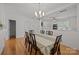 Bright dining room with modern chandelier and hardwood floors at 11139 Dundarrach Ln, Charlotte, NC 28277