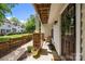 Covered front porch with wooden chairs, stone supports, wood ceiling and a decorative front door wreath at 11139 Dundarrach Ln, Charlotte, NC 28277