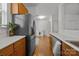 Bright kitchen with stainless steel appliances, wood cabinets and hardwood floors at 11139 Dundarrach Ln, Charlotte, NC 28277