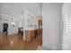 An open kitchen with stainless steel appliances, wooden cabinets and a view into the dining room at 11139 Dundarrach Ln, Charlotte, NC 28277