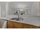 Modern kitchen with a stainless steel sink, wood cabinets, and a view into the living area at 11139 Dundarrach Ln, Charlotte, NC 28277