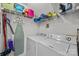 Efficient laundry room with a washer, dryer, and storage shelves for all cleaning supplies at 11139 Dundarrach Ln, Charlotte, NC 28277