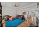 Cozy living room with hardwood floors, ceiling fan, and bright turquoise rug at 11139 Dundarrach Ln, Charlotte, NC 28277