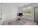 Home office featuring a desk, a chair, and a window overlooking the exterior at 11139 Dundarrach Ln, Charlotte, NC 28277