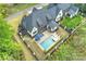 Aerial view of a home with a private backyard featuring a pool, patio, and manicured lawn at 1118 Jefferson Dr, Charlotte, NC 28270