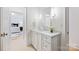 Bright bathroom with white vanity, marble countertop, and decorative flower arrangement at 1118 Jefferson Dr, Charlotte, NC 28270