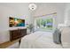 A bedroom offers backyard view through its windows and a ceiling with a modern chandelier at 1118 Jefferson Dr, Charlotte, NC 28270