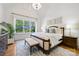 A bright bedroom features large window, tray ceiling, and neutral decor at 1118 Jefferson Dr, Charlotte, NC 28270