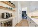 Butler pantry features floating shelves, built-in wine fridge and ample storage space at 1118 Jefferson Dr, Charlotte, NC 28270