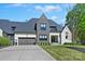 Stunning home featuring a modern design, meticulously landscaped yard, and a spacious driveway leading to an attached two-car garage at 1118 Jefferson Dr, Charlotte, NC 28270