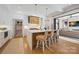 Bright kitchen features a large island with seating and modern appliances, seamlessly connected to the living area at 1118 Jefferson Dr, Charlotte, NC 28270