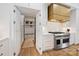 Modern kitchen featuring sleek cabinets, a professional-grade range, and a doorway to the mudroom for convenience at 1118 Jefferson Dr, Charlotte, NC 28270