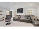 Cozy living room featuring a gray leather sofa, accent chair, and recessed lighting at 1118 Jefferson Dr, Charlotte, NC 28270