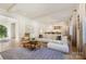 Open-concept living room featuring a view of the kitchen, hardwood floors, and abundant natural light for comfortable living at 1118 Jefferson Dr, Charlotte, NC 28270