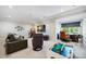 Spacious living room area with comfortable seating, desk, and various entertainment options at 1118 Jefferson Dr, Charlotte, NC 28270