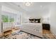 Bright main bedroom with sitting area, neutral decor, and hardwood flooring at 1118 Jefferson Dr, Charlotte, NC 28270