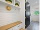 A mudroom features a bench with storage, shelving, and patterned tile floor at 1118 Jefferson Dr, Charlotte, NC 28270