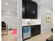 Modern wet bar with dark cabinetry, white countertops, and a beverage refrigerator at 1118 Jefferson Dr, Charlotte, NC 28270