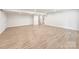 Spacious basement featuring recessed lighting, neutral paint, and hardwood style flooring throughout at 1123 Fern Hill Rd, Mooresville, NC 28117