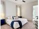 Bright bedroom featuring neutral walls, patterned pillows, a blue throw blanket, and natural light from the window at 1123 Fern Hill Rd, Mooresville, NC 28117