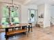 Spacious dining room featuring a long wooden table and large window with backyard views at 1123 Fern Hill Rd, Mooresville, NC 28117