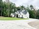 A view of the home's exterior and long driveway, surrounded by mature trees at 1123 Fern Hill Rd, Mooresville, NC 28117