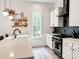 Bright kitchen with white countertops, modern appliances, and decorative shelving at 1123 Fern Hill Rd, Mooresville, NC 28117