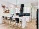 Modern kitchen with a breakfast bar, sleek black backsplash, and pendant lighting at 1123 Fern Hill Rd, Mooresville, NC 28117