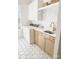 Bright laundry room featuring shaker cabinets, quartz countertop, and modern fixtures at 1123 Fern Hill Rd, Mooresville, NC 28117