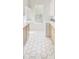 Well-lit laundry room with white cabinets, stylish hardware, and patterned tile flooring at 1123 Fern Hill Rd, Mooresville, NC 28117